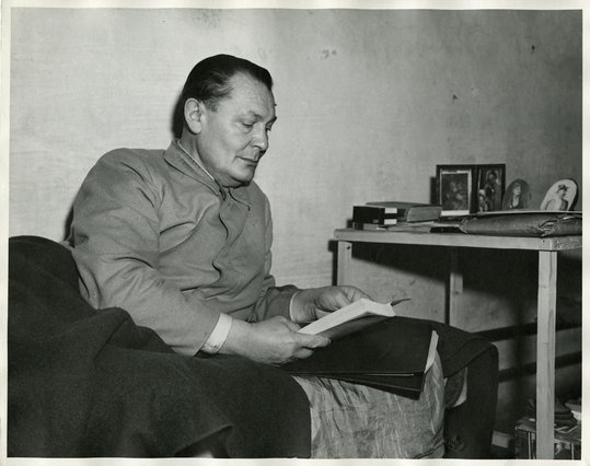 Göring in his cell at Nuremberg Prison next to photos of family members, December 21, 1945
